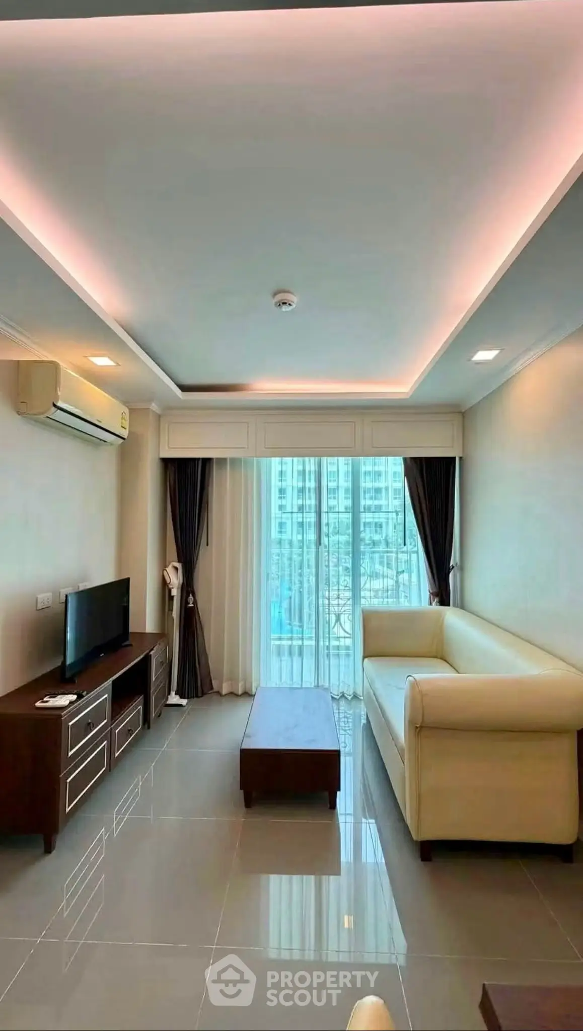 Modern living room with sleek design, large windows, and elegant furniture in a high-rise apartment.