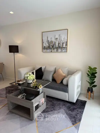 Modern living room with stylish sofa, chic decor, and elegant coffee table in a cozy apartment.