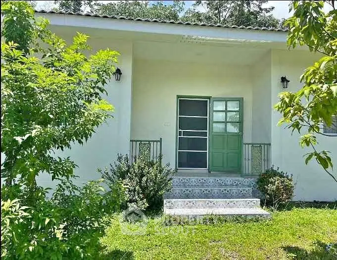 Charming single-story home with lush greenery and inviting entrance.