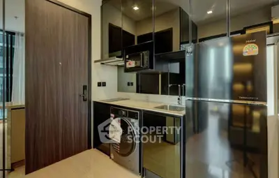Modern kitchen with sleek appliances and washing machine in stylish apartment