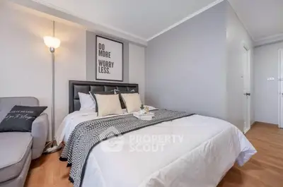 Modern bedroom with stylish decor and cozy ambiance, featuring a comfortable bed and elegant lighting.