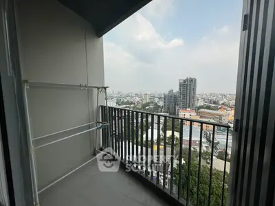 Spacious balcony with stunning city view in modern high-rise apartment