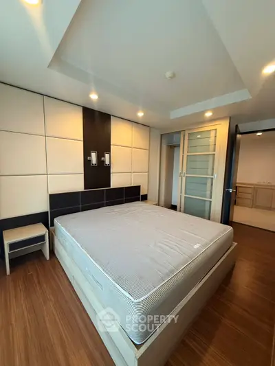 Modern bedroom with sleek design and wooden flooring