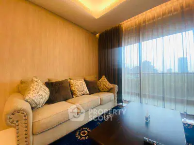 Luxurious living room with elegant sofa and city view through large window.