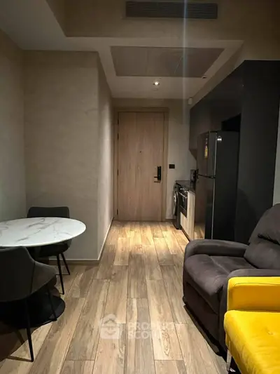 Modern apartment interior with cozy living area and compact kitchen