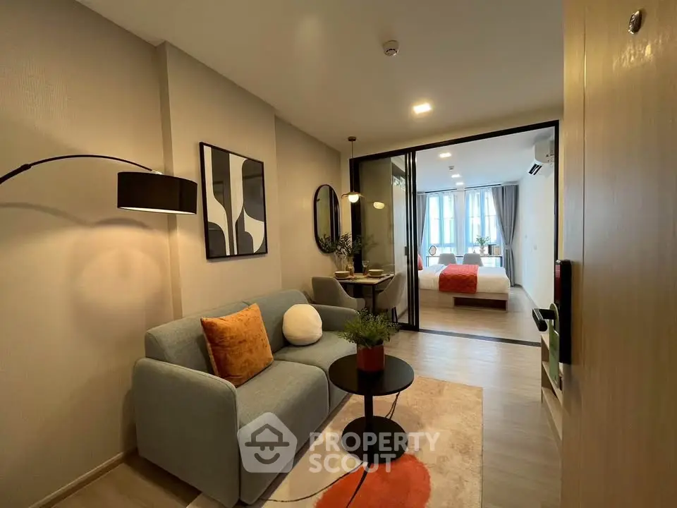 Modern open-plan living room with stylish decor and cozy ambiance in a contemporary apartment.