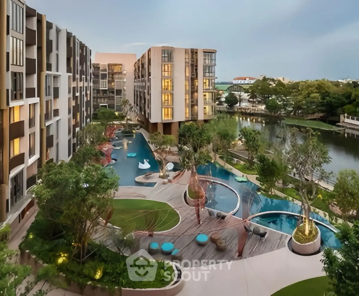 Luxurious modern apartment complex with stunning landscaped garden and pool view.