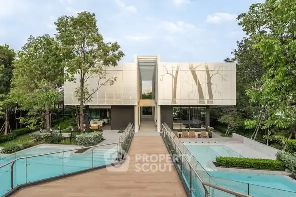 Luxurious modern home with stunning pool and lush garden surroundings.