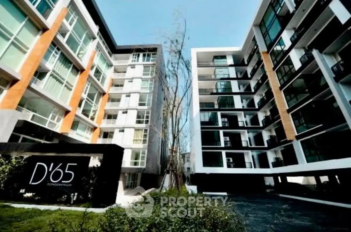 Modern condominium exterior with sleek design and lush greenery at D'65.