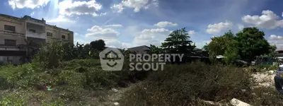 Spacious land plot with lush greenery and clear blue sky, ideal for development opportunities.