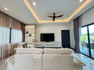 Luxurious modern living room with elegant lighting and spacious seating area.