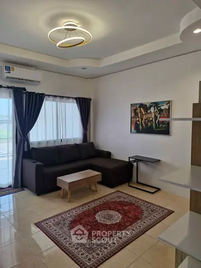Modern living room with stylish sofa, elegant lighting, and chic decor for a cozy ambiance.