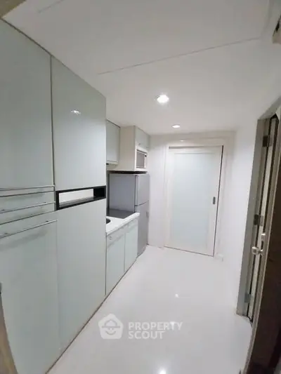 Modern compact kitchen with sleek cabinets and appliances