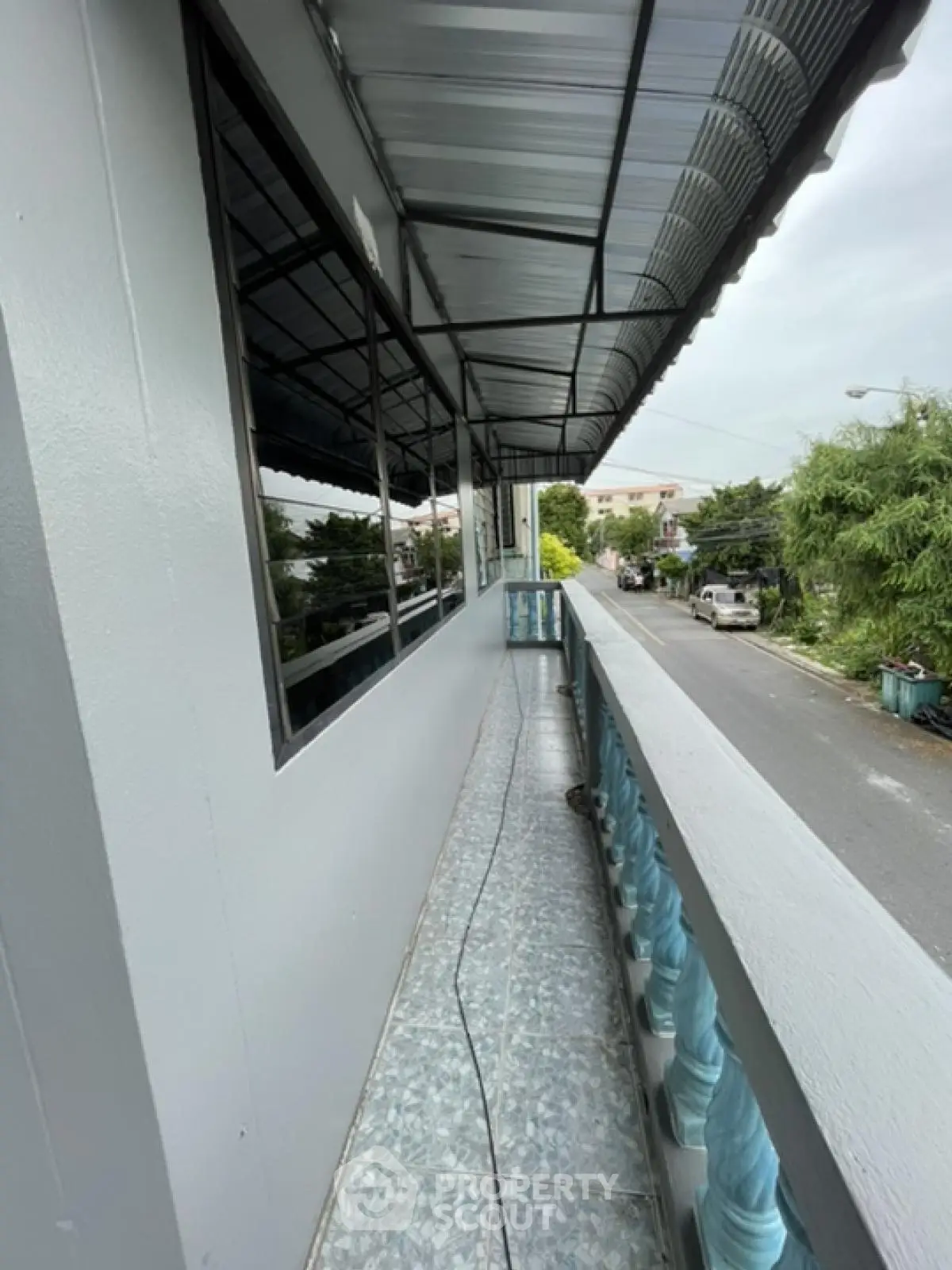 Spacious balcony with street view in modern residential building