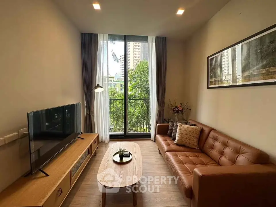 Modern living room with leather sofa, large window, and stylish decor in urban apartment.