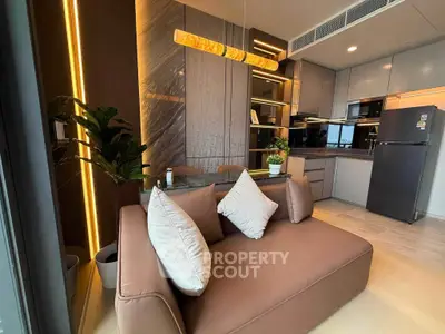 Modern open-layout kitchen and living area with stylish decor and sleek appliances.