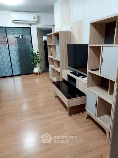 Modern living room with wooden flooring and stylish shelving unit