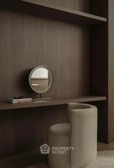Elegant study nook with modern chair and round mirror on wooden shelf, perfect for a minimalist home office.
