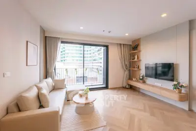 Modern living room with large window and balcony view in urban apartment