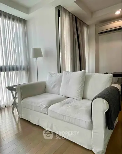 Modern living room with cozy white sofa and elegant decor