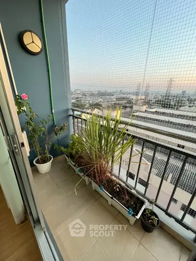 Charming balcony with city view and lush potted plants, perfect for relaxation.