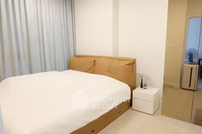 Modern bedroom with cozy bed and sleek decor in a stylish apartment.