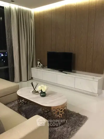 Luxurious modern living room with elegant decor and ambient lighting.