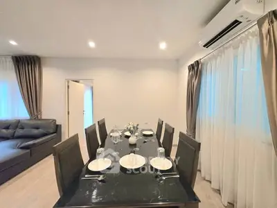 Elegant dining area with modern decor and ample natural light, perfect for entertaining guests.