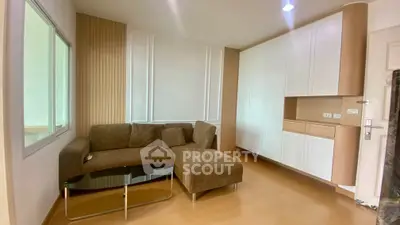 Modern living room with stylish brown sofa and sleek cabinetry