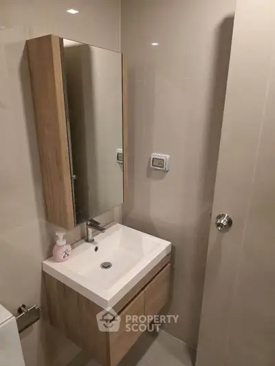 Modern bathroom with sleek vanity and mirror in compact space