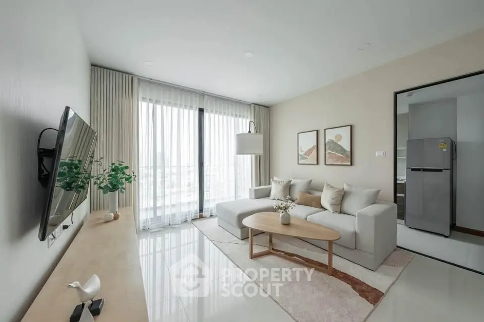 Modern living room with sleek design, large windows, and stylish furniture in a contemporary apartment.