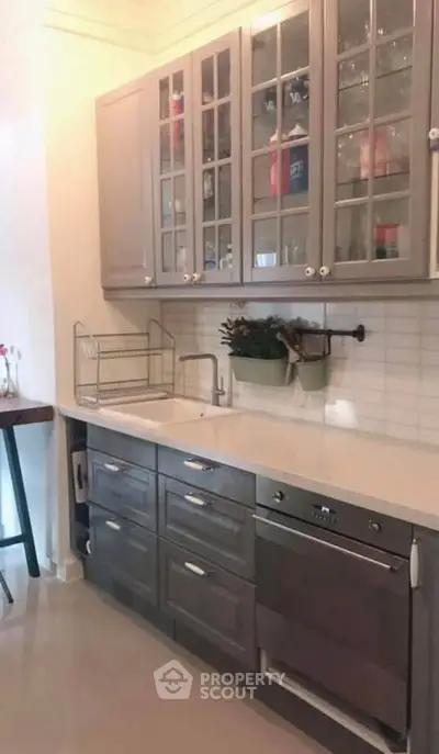 Stylish kitchen with modern cabinetry and built-in oven