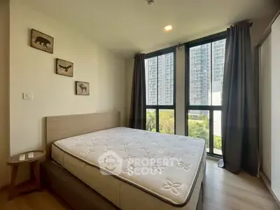 Spacious bedroom with large windows and modern decor in urban apartment