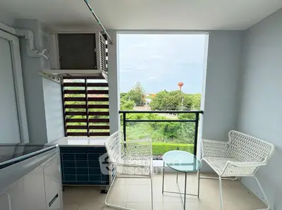 Charming balcony with seating and scenic view, perfect for relaxation.