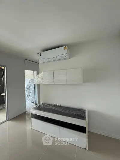 Modern minimalist kitchen with air conditioning and sleek cabinetry