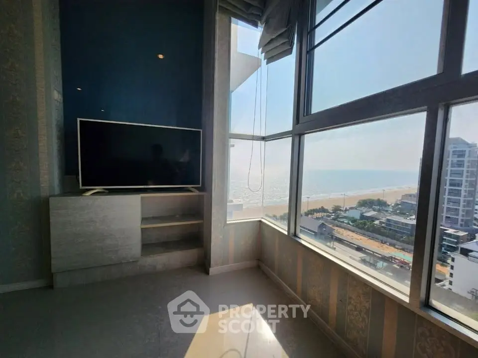 Stunning beachfront living room with panoramic ocean views and modern decor.