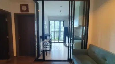 Modern apartment interior with open kitchen and balcony view
