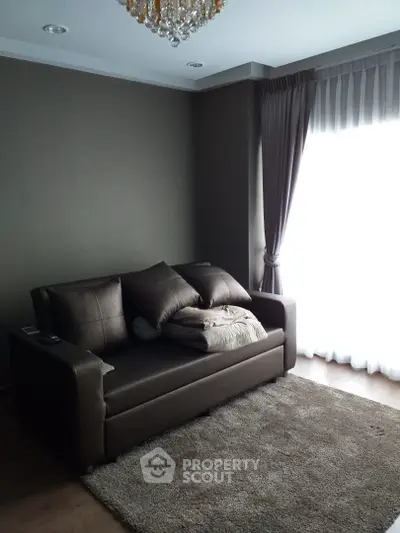 Cozy living room with elegant sofa and natural light from large window