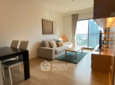 Modern living room with city view, stylish furniture, and natural light.