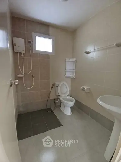 Spacious bathroom with modern fixtures and neutral tiles