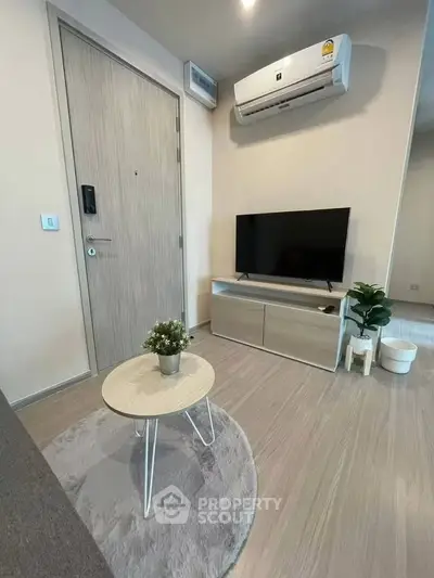 Modern living room with sleek TV setup and air conditioning, perfect for cozy relaxation.