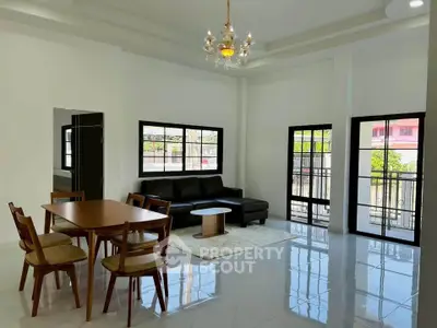 Spacious living room with elegant chandelier and modern furniture