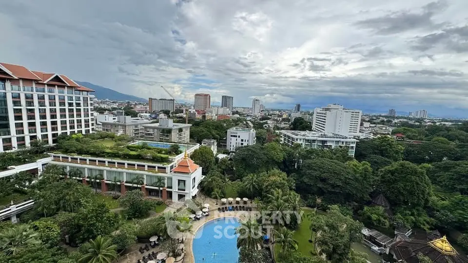 Stunning cityscape view with lush greenery and inviting pool area from a high-rise building.