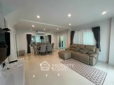 Spacious modern living room with elegant dining area and cozy seating.