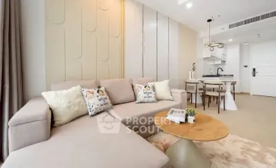 Modern living room with cozy beige sofa and stylish open kitchen layout