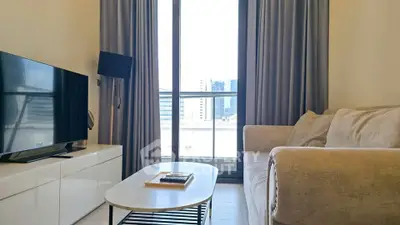 Modern living room with large window and cozy sofa in a stylish apartment.