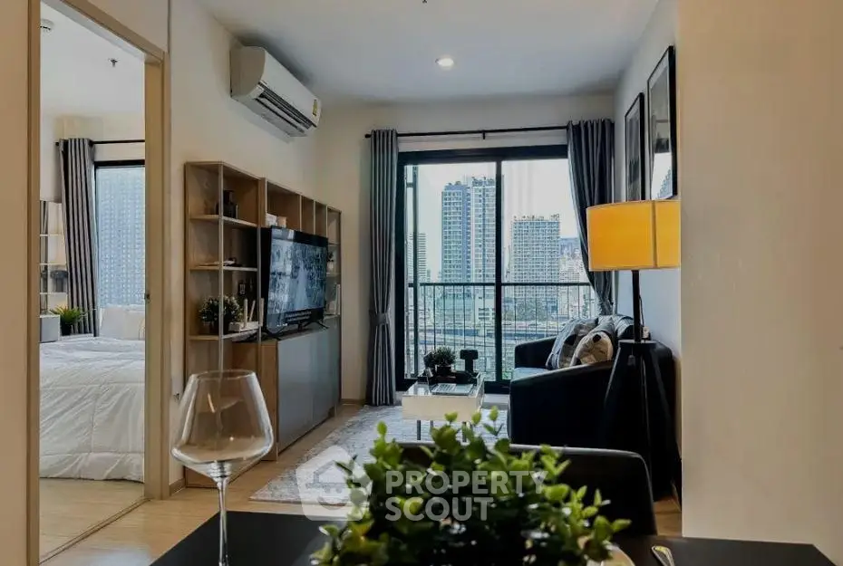 Modern living room with city view, stylish decor, and open layout in urban apartment.