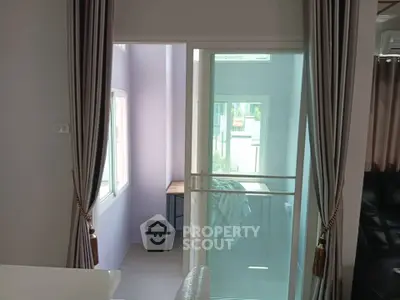 Modern interior with sliding glass door and elegant curtains, showcasing a bright and airy living space.