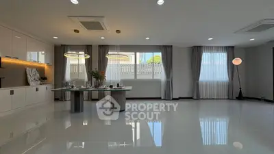 Spacious modern living room with elegant lighting and large windows