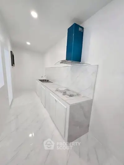 Sleek modern kitchen with marble finishes and high-end appliances